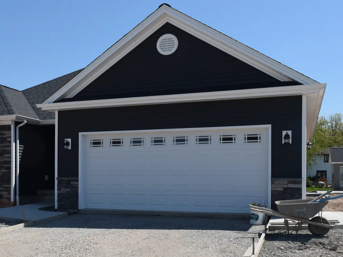 House with dark siding, white trim and an asphalt shingle roof