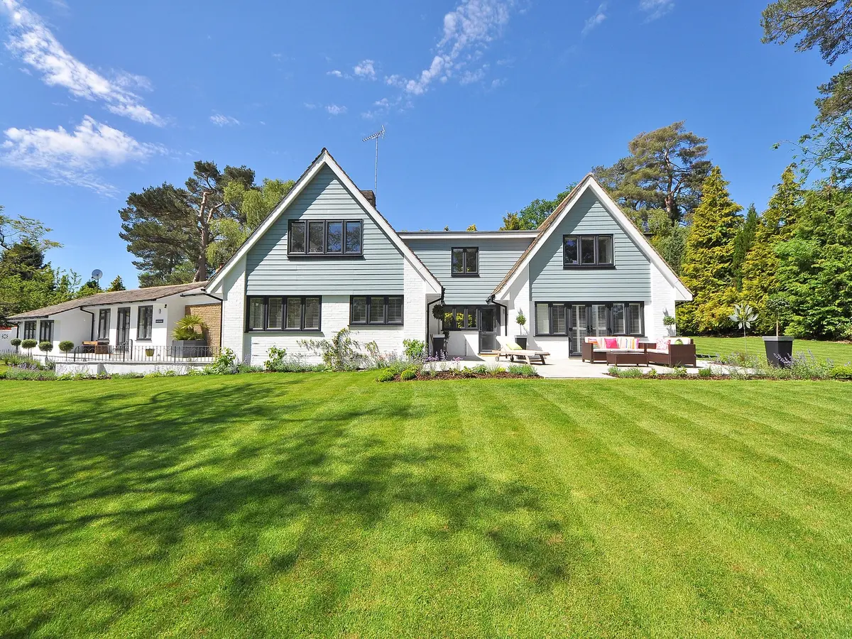 House with white and blue horizontal siding behind a lawn