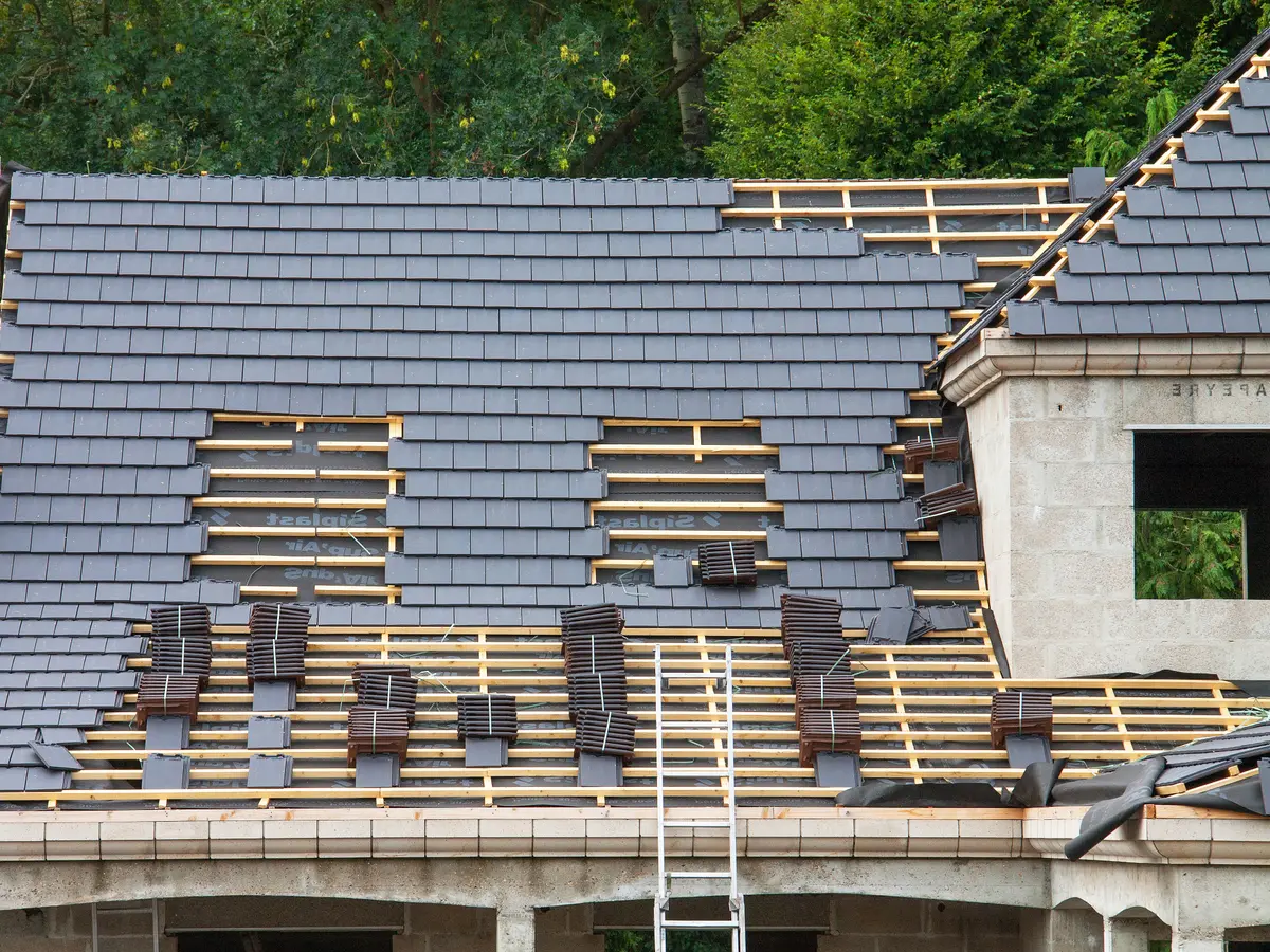 House part way through a roof replacement, with new covering on battens
