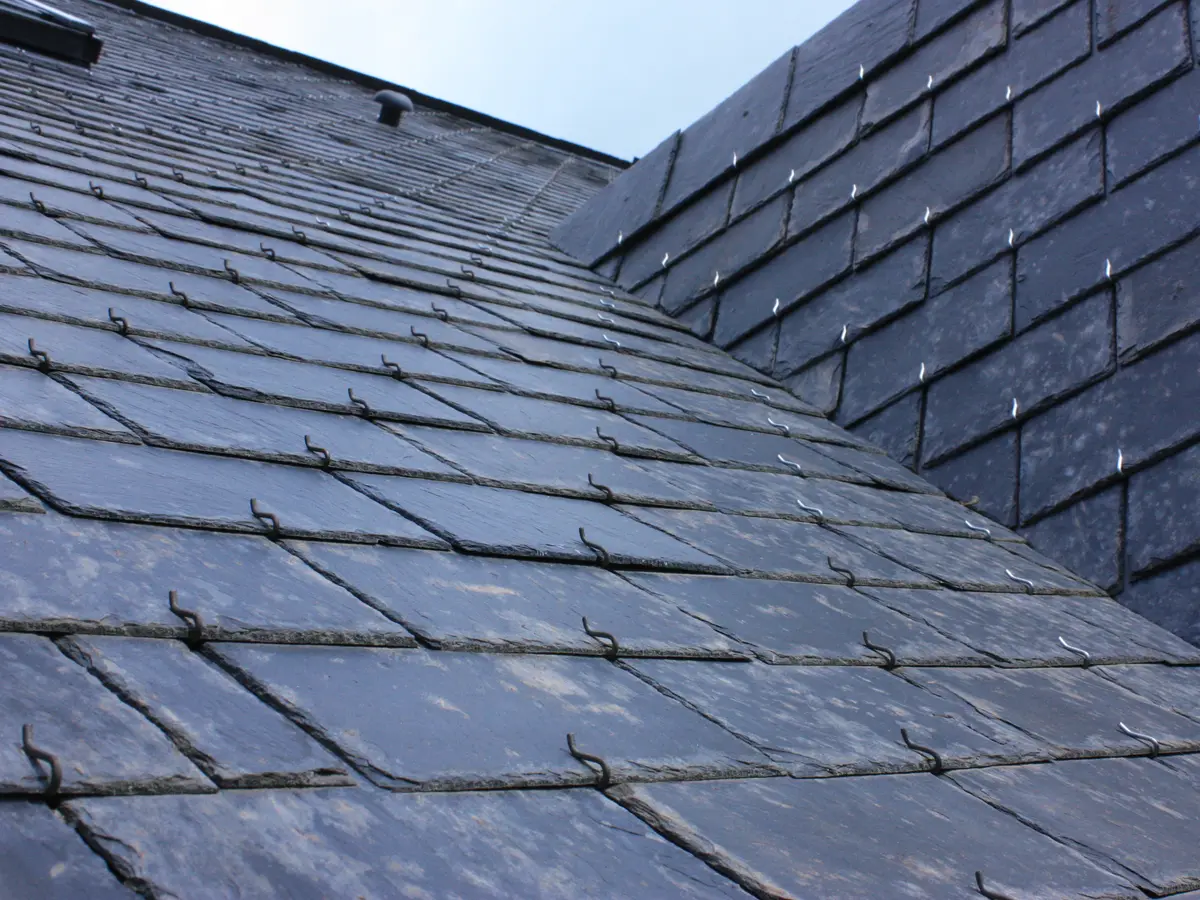 Natural slate roof slopes meeting at a valley