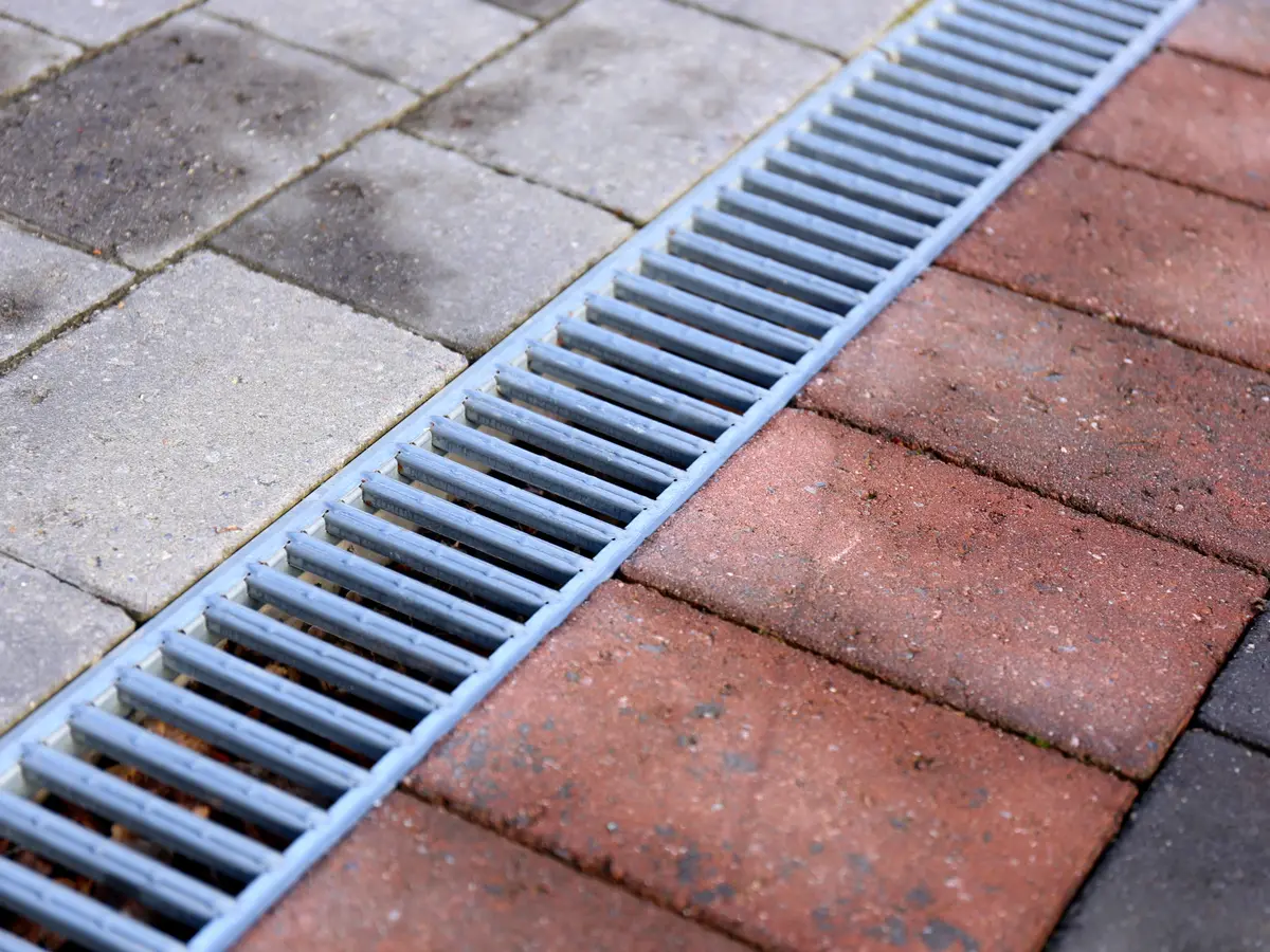 Channel drain set between pavers