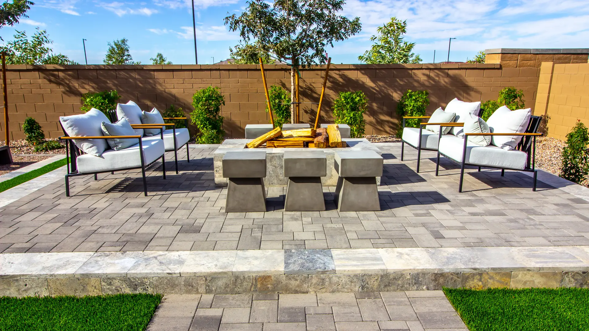 Modern paver patio with outdoor seating around a fire table