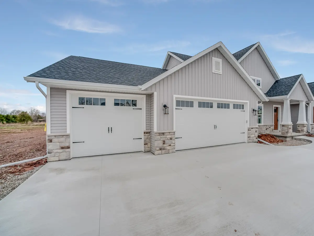 New house with board and batten siding and stone trim